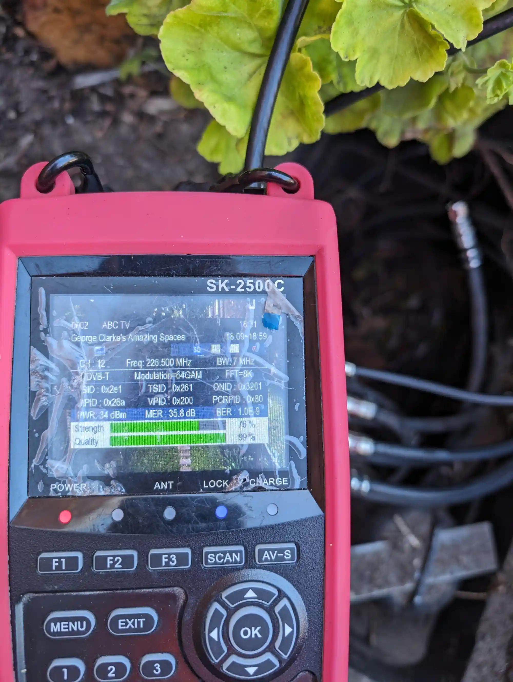 Close-up of TV signal meter checking digital TV and MATV reception at aged care facility in Perth