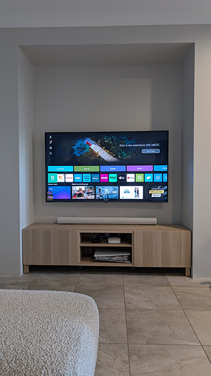 A TV wall mounted on the wall with cables hidden